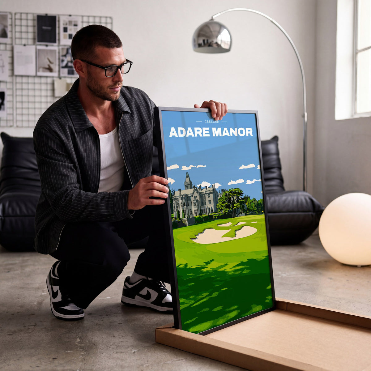 Adare Manor golf print of the manor house behind a green and bunkers, being unboxed in a bright studio