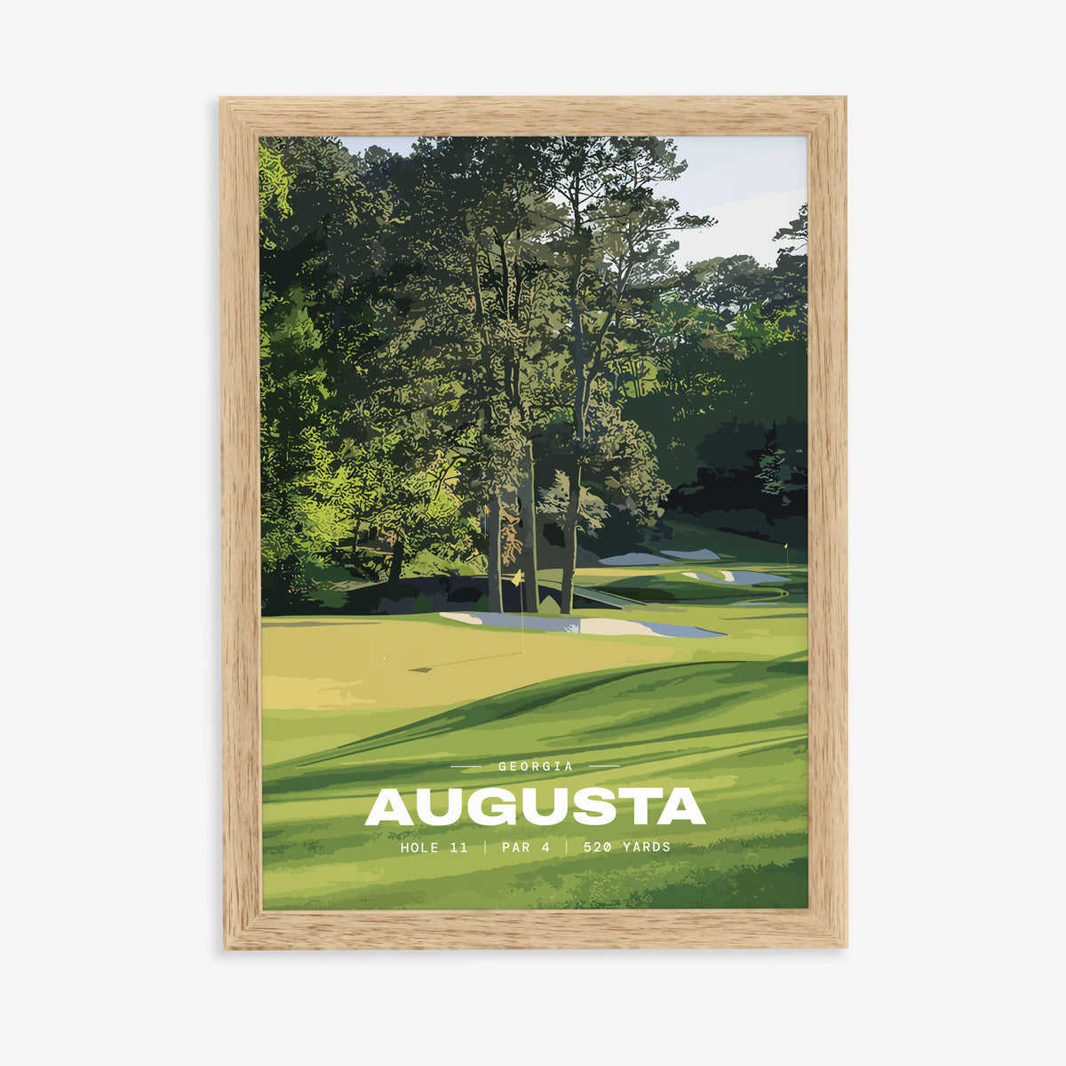 Augusta 11th hole golf print of a green below tall Georgia pines, in a natural wood frame on a plain wall