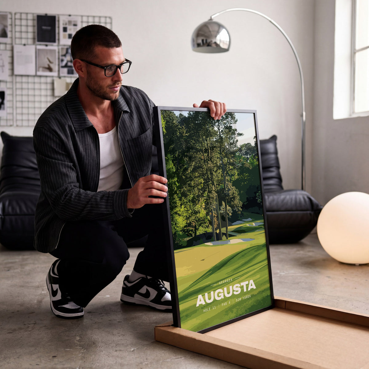 Augusta 11th hole golf print of a green below tall Georgia pines, being unboxed in a bright studio