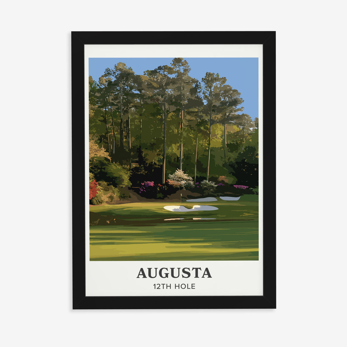 Augusta 12th hole golf print of a par 3 green below azaleas, cream border, in a black frame on a plain wall