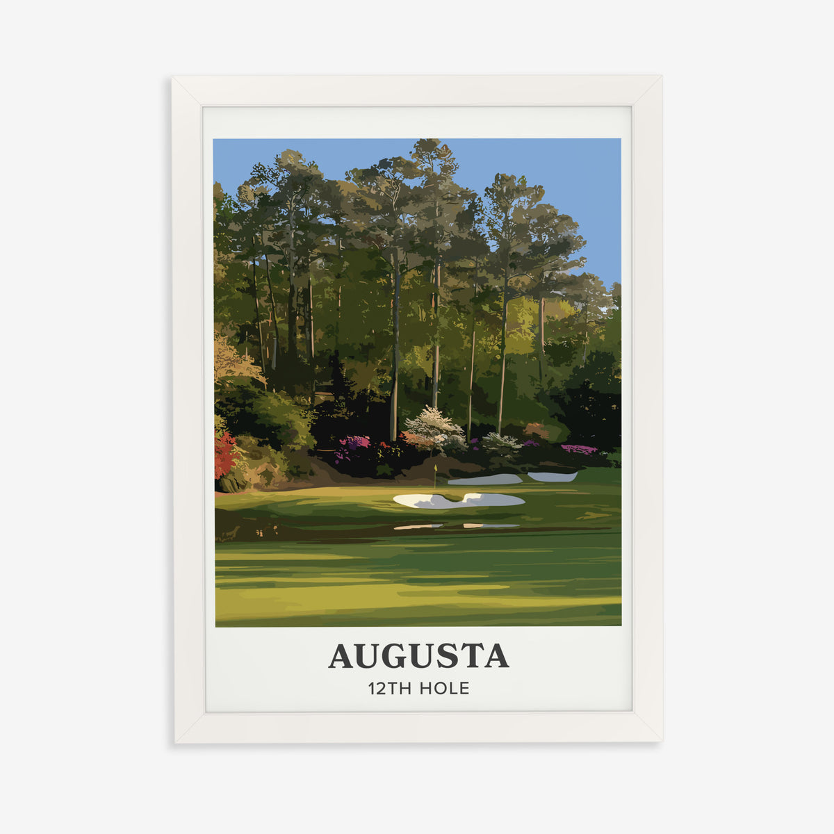 Augusta 12th hole golf print of a par 3 green below azaleas, cream border, in a white frame on a plain wall