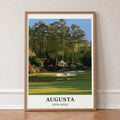 Augusta 12th hole golf print of a par 3 green below azaleas, cream border, in an oak frame, leaning against a wall on a herringbone floor