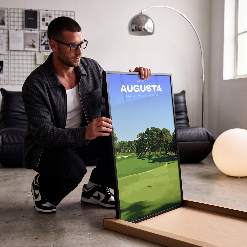 Augusta 1st hole golf print of an uphill fairway to a yellow flag, being unboxed in a bright studio