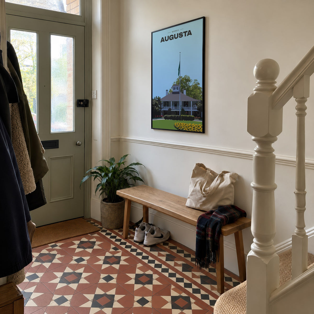 Augusta The Clubhouse golf print of the white clubhouse and yellow flowers, framed in a hallway with patterned floor tiles