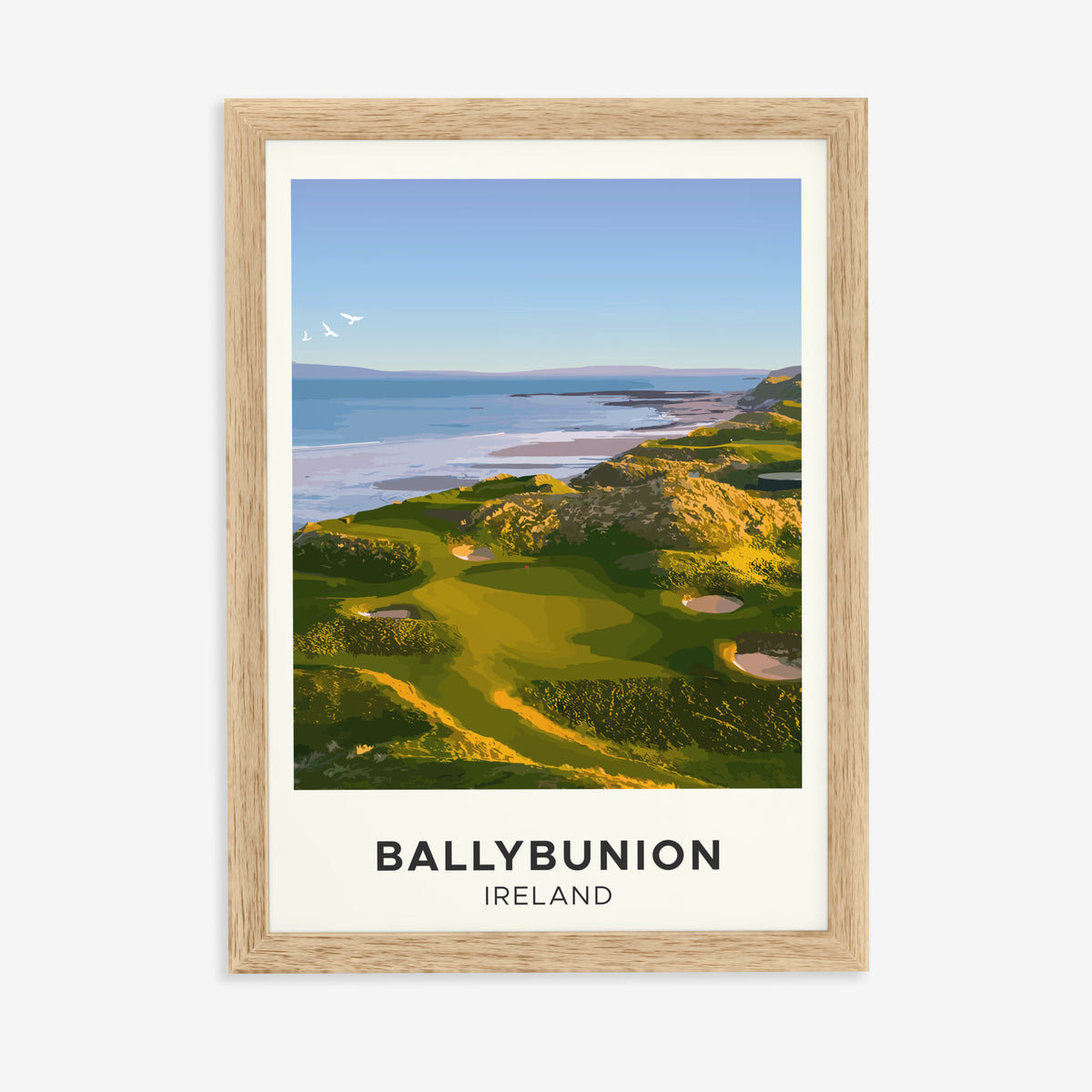Ballybunion golf print of links greens above the sea, cream border, in a natural wood frame on a plain wall