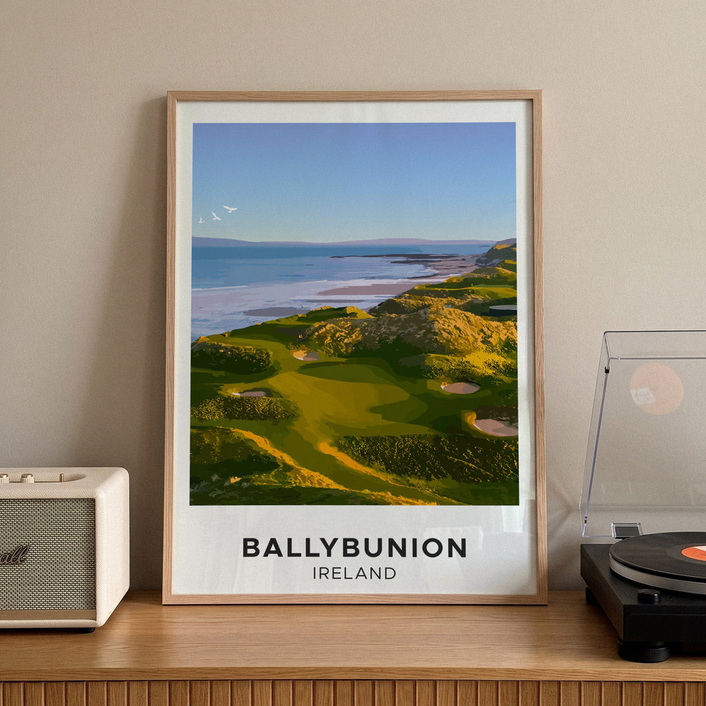 Ballybunion golf print of links greens above the sea, cream border, framed on a sideboard beside a record player