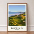 Ballybunion golf print of links greens above the sea, cream border, in an oak frame, leaning against a wall on a herringbone floor