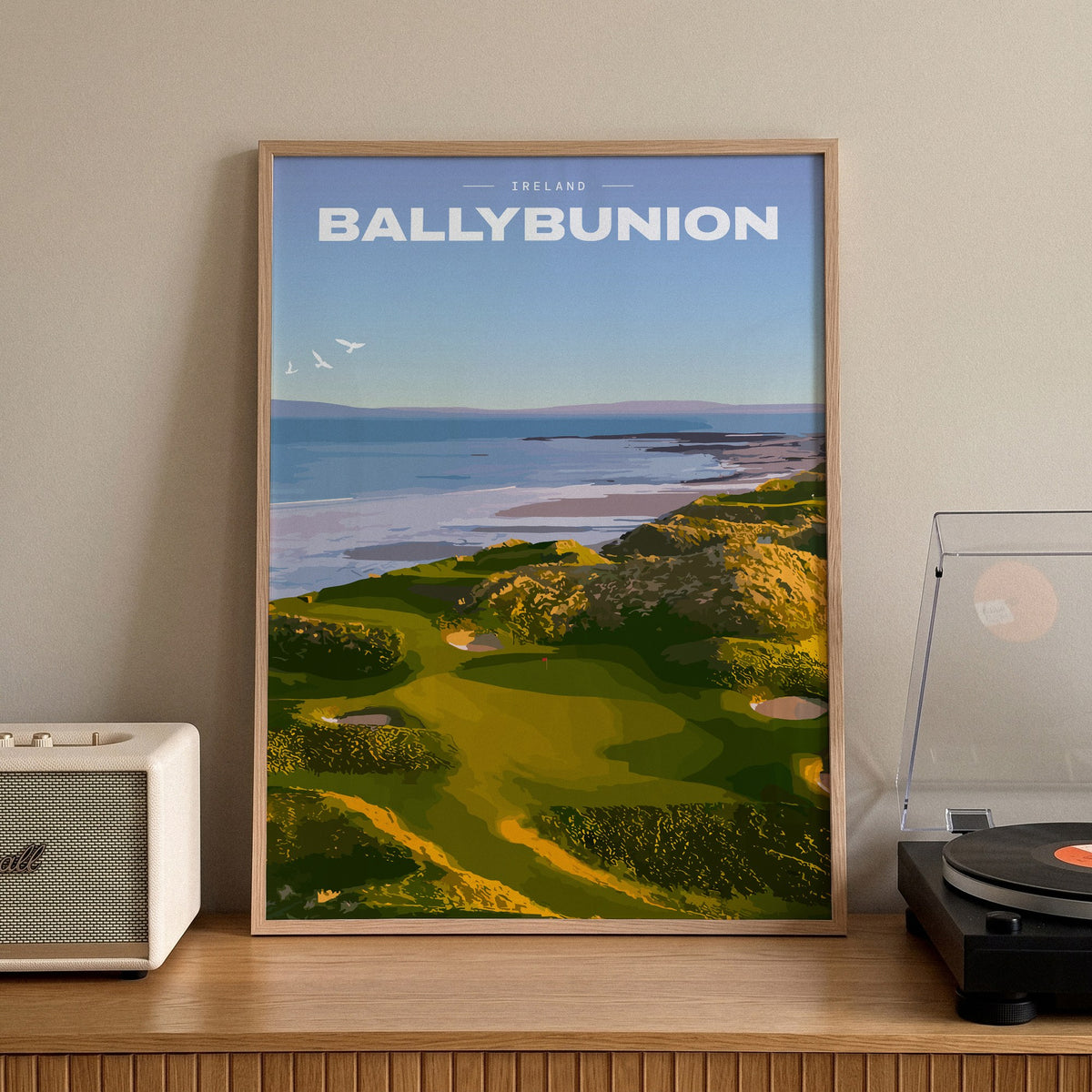 Ballybunion golf print of links greens in the dunes above the sea, framed on a sideboard beside a record player