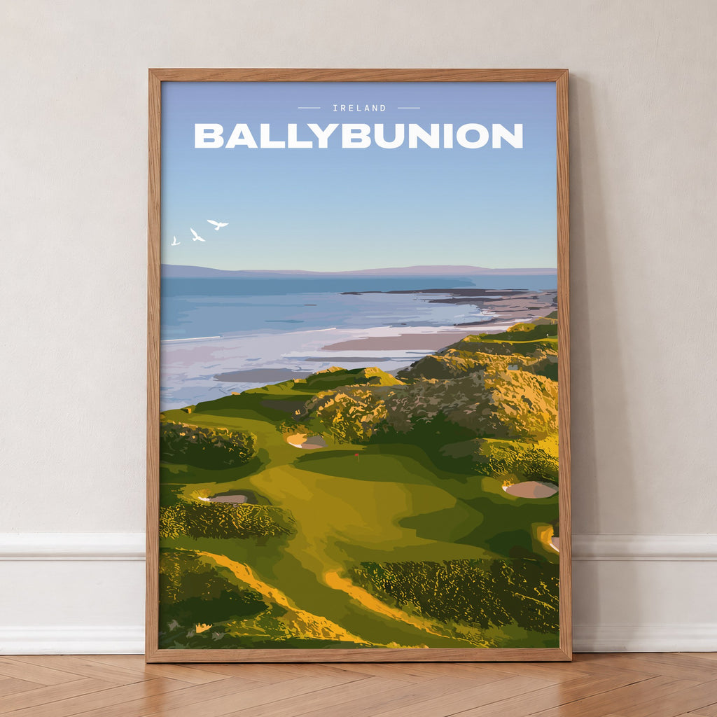 Ballybunion golf print of links greens in the dunes above the sea, in an oak frame, leaning against a wall on a herringbone floor