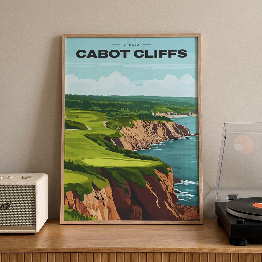 Cabot Cliffs golf print of a green on red clifftops above the sea, framed on a sideboard beside a record player