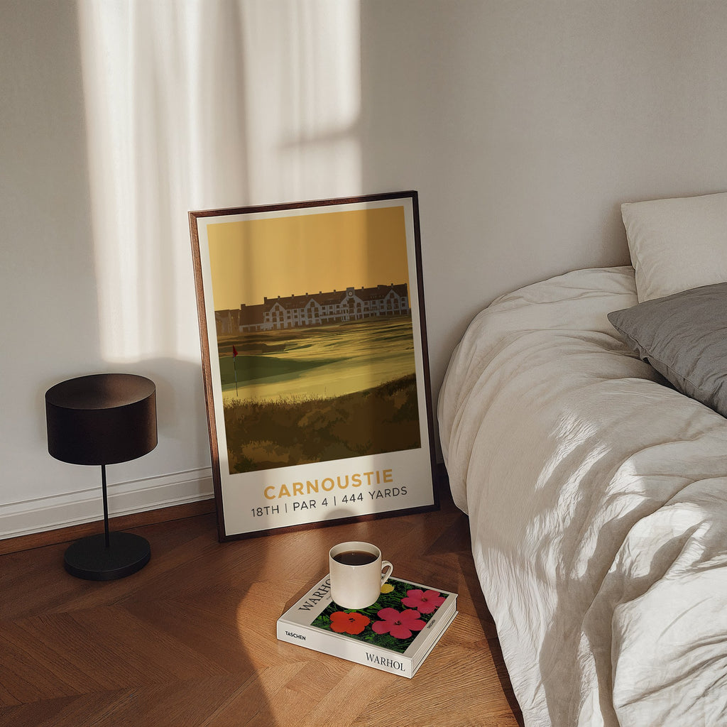 Carnoustie 18th hole golf print of the 18th green in golden light, framed, leaning by a bed
