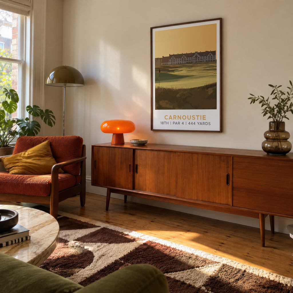 Carnoustie 18th hole golf print of the 18th green in golden light, framed above a teak sideboard