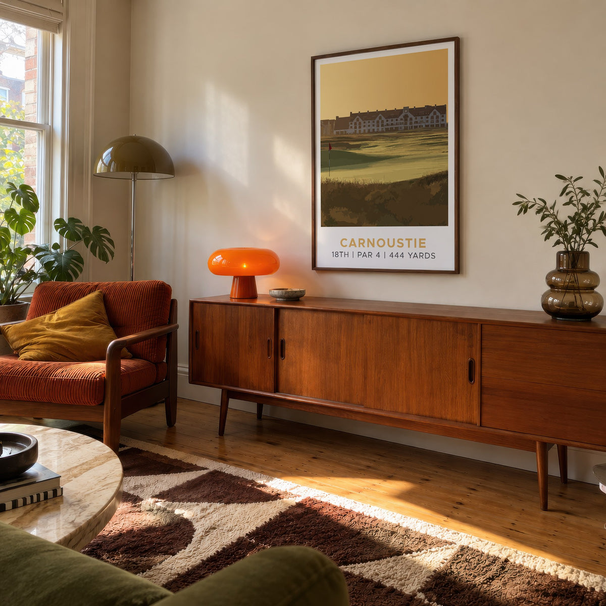 Carnoustie 18th hole golf print of the 18th green in golden light, framed above a teak sideboard
