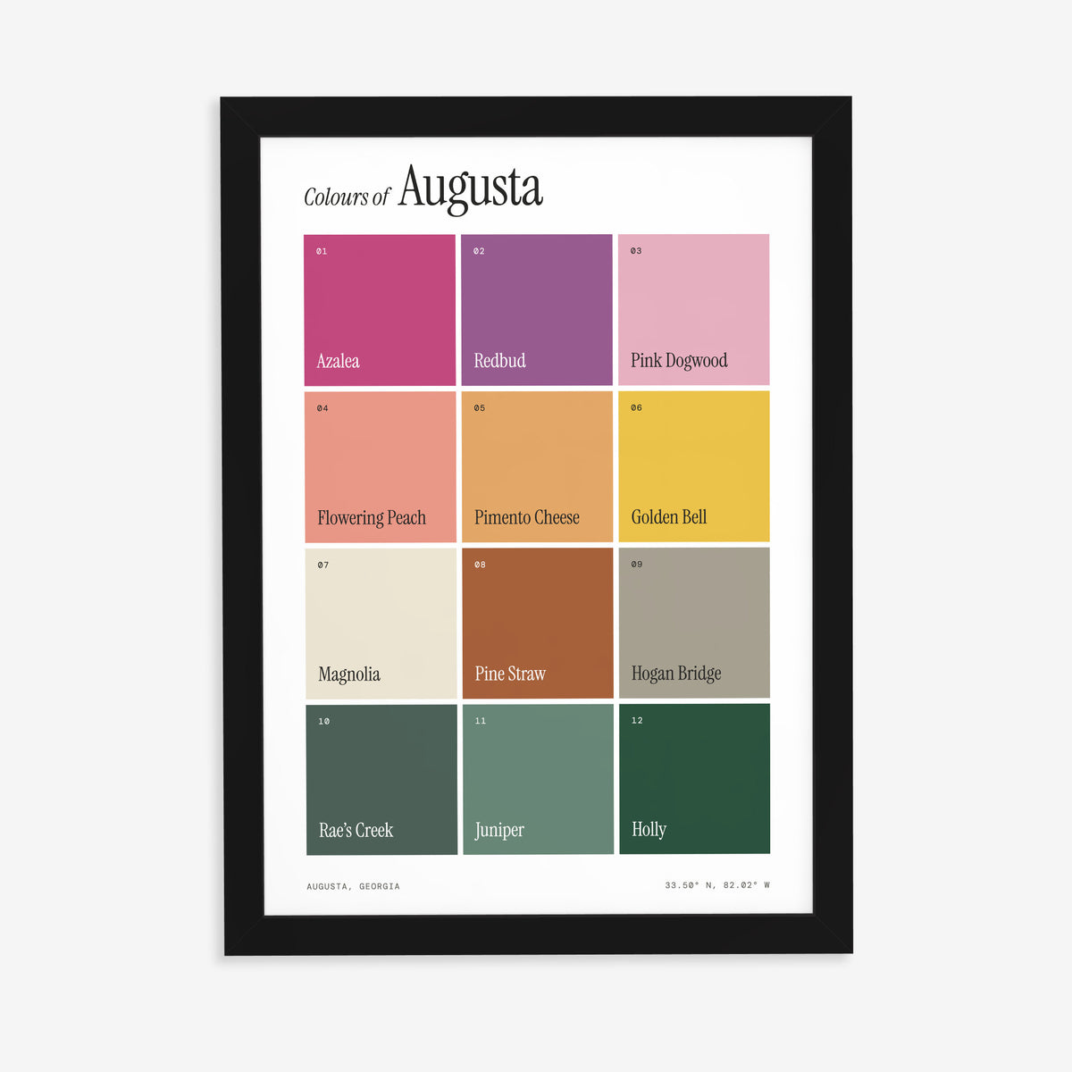 Colours of Augusta print of twelve named colour squares on white, in a black frame on a plain wall