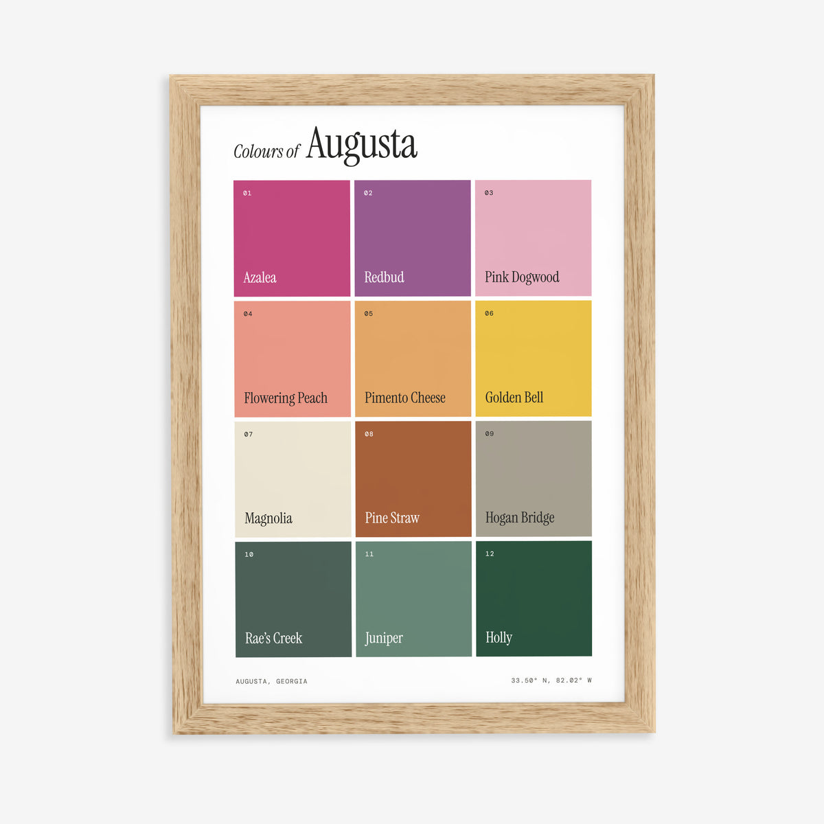 Colours of Augusta print of twelve named colour squares on white, in a natural wood frame on a plain wall
