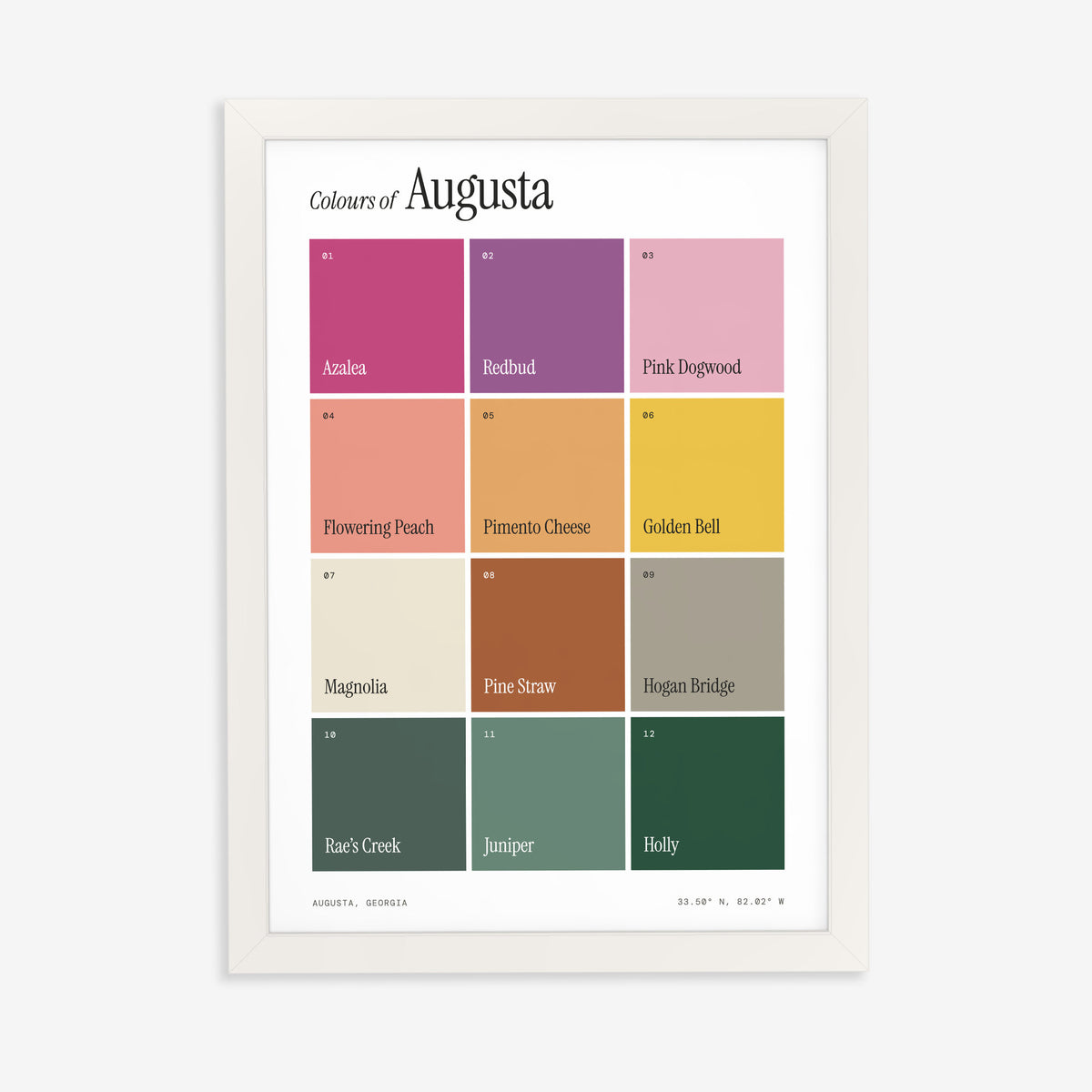 Colours of Augusta print of twelve named colour squares on white, in a white frame on a plain wall
