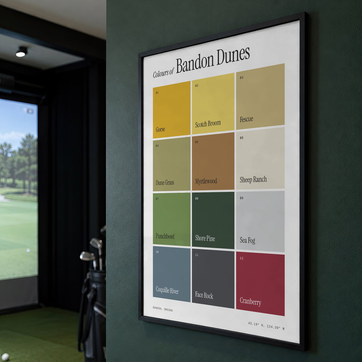 Colours of Bandon Dunes print of twelve named colour squares on white, framed on a green wall beside a golf simulator