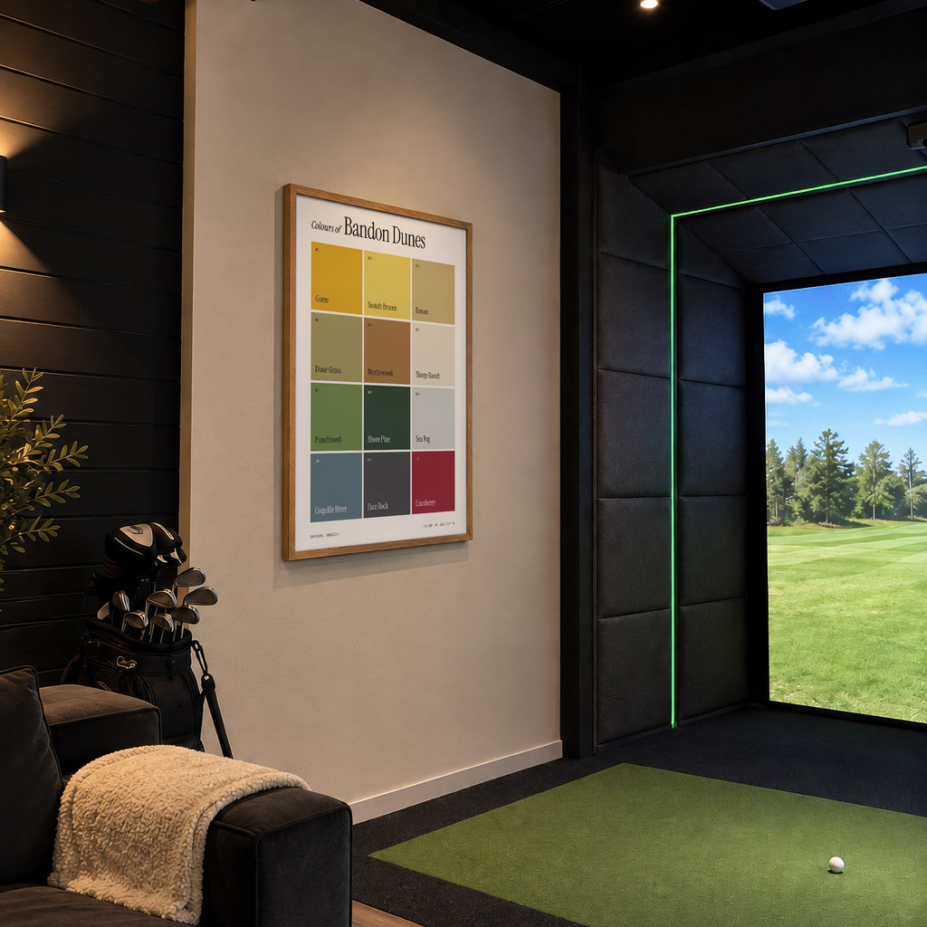 Colours of Bandon Dunes print of twelve named colour squares on white, framed in a golf simulator room