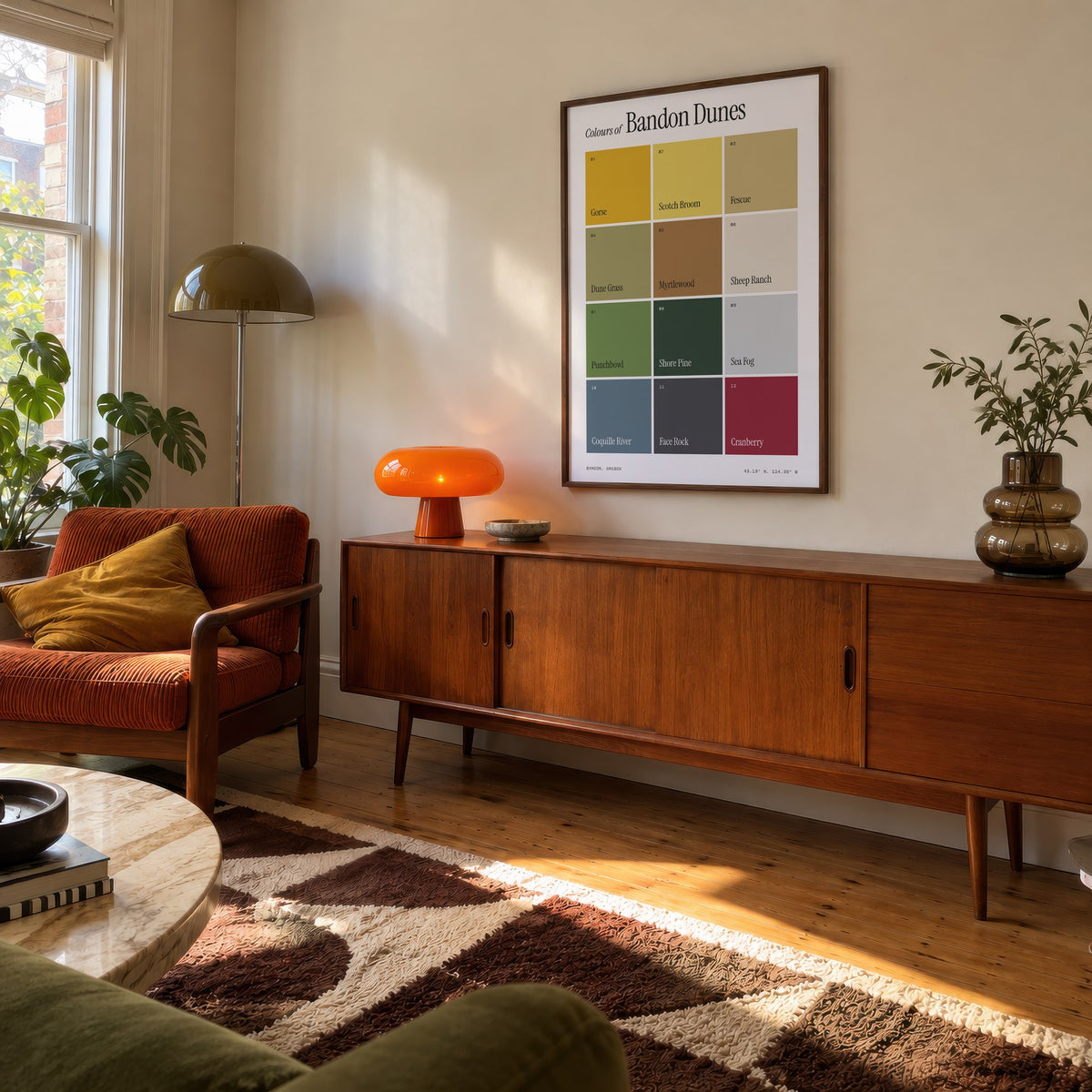 Colours of Bandon Dunes print of twelve named colour squares on white, framed above a teak sideboard