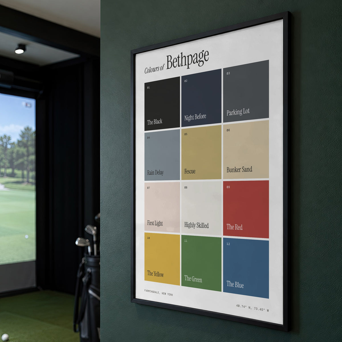 Colours of Bethpage print of twelve named colour squares on white, framed on a green wall beside a golf simulator