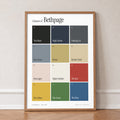 Colours of Bethpage print of twelve named colour squares on white, in an oak frame, leaning against a wall on a herringbone floor