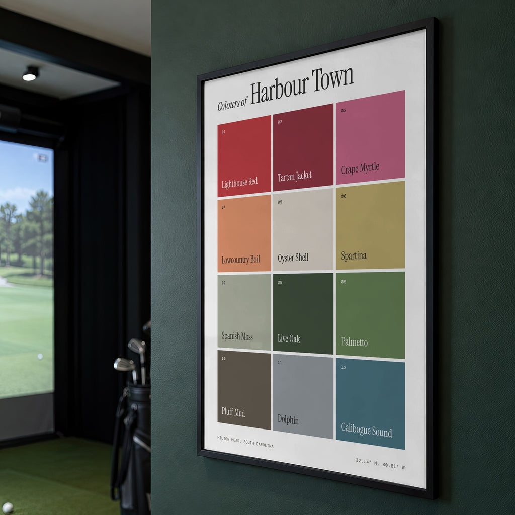 Colours of Harbour Town print of twelve named colour squares on white, framed on a green wall beside a golf simulator
