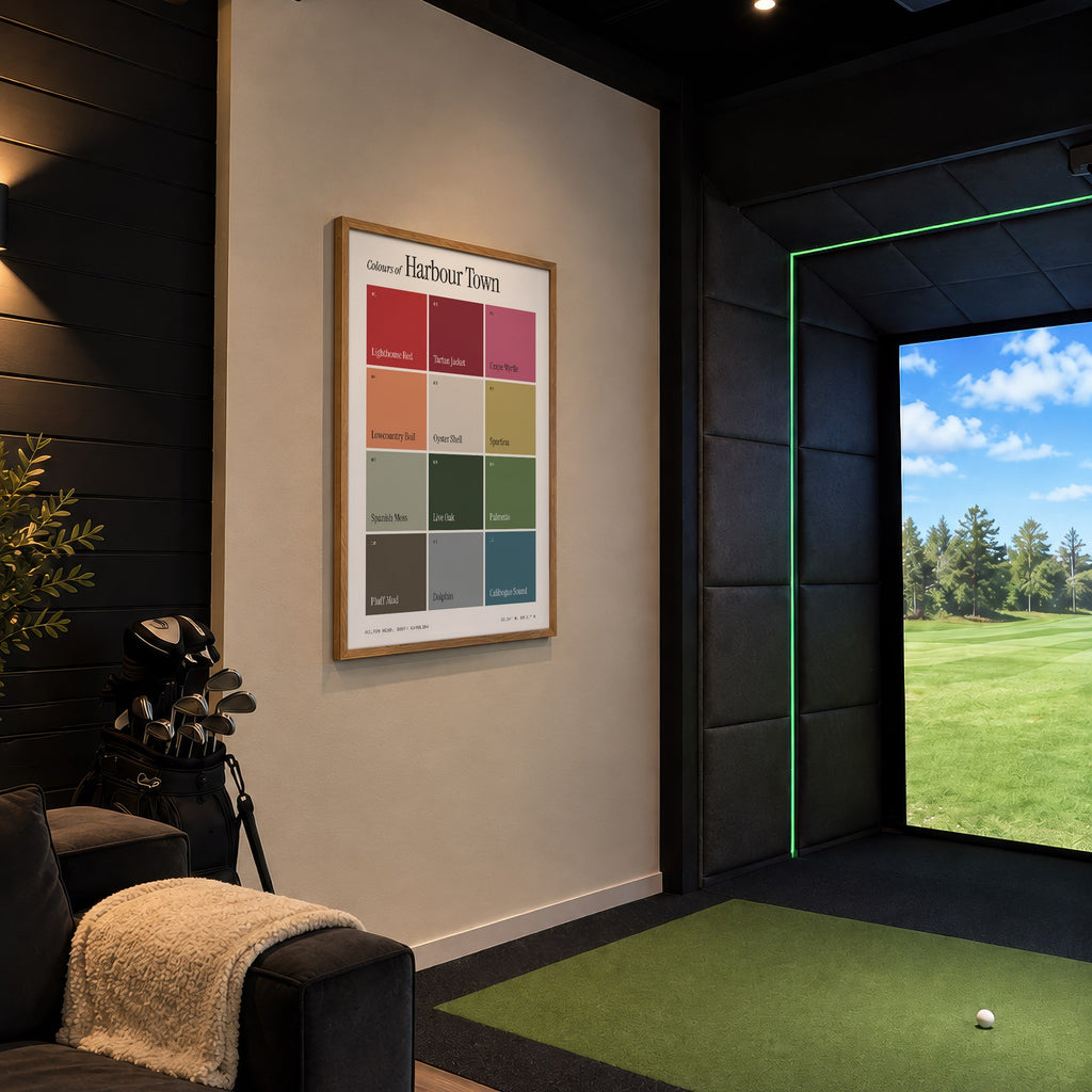 Colours of Harbour Town print of twelve named colour squares on white, framed in a golf simulator room