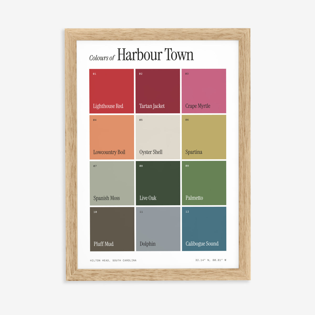 Colours of Harbour Town print of twelve named colour squares on white, in a natural wood frame on a plain wall