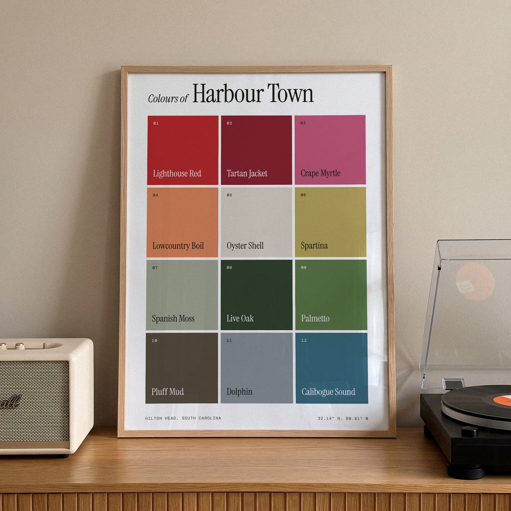 Colours of Harbour Town print of twelve named colour squares on white, framed on a sideboard beside a record player