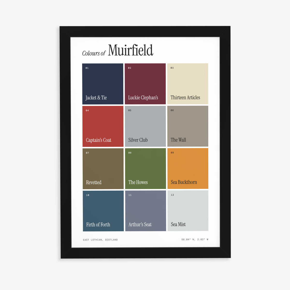 Colours of Muirfield print of twelve named colour squares on white, in a black frame on a plain wall