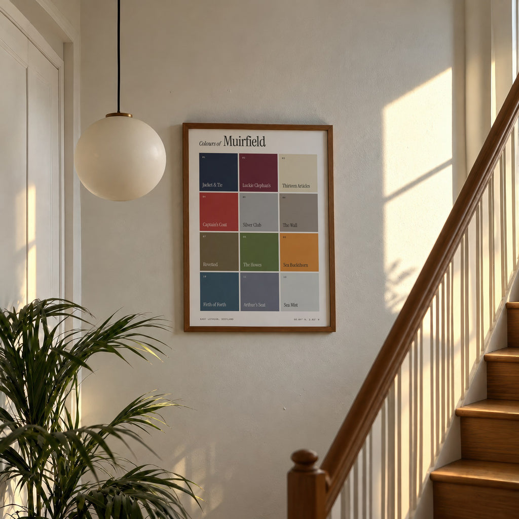 Colours of Muirfield print of twelve named colour squares on white, framed above a sunlit staircase