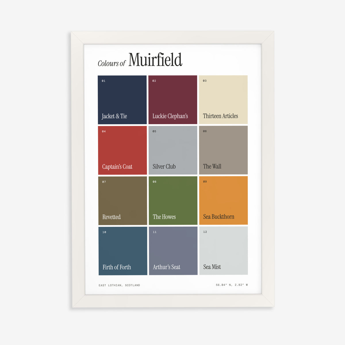 Colours of Muirfield print of twelve named colour squares on white, in a white frame on a plain wall