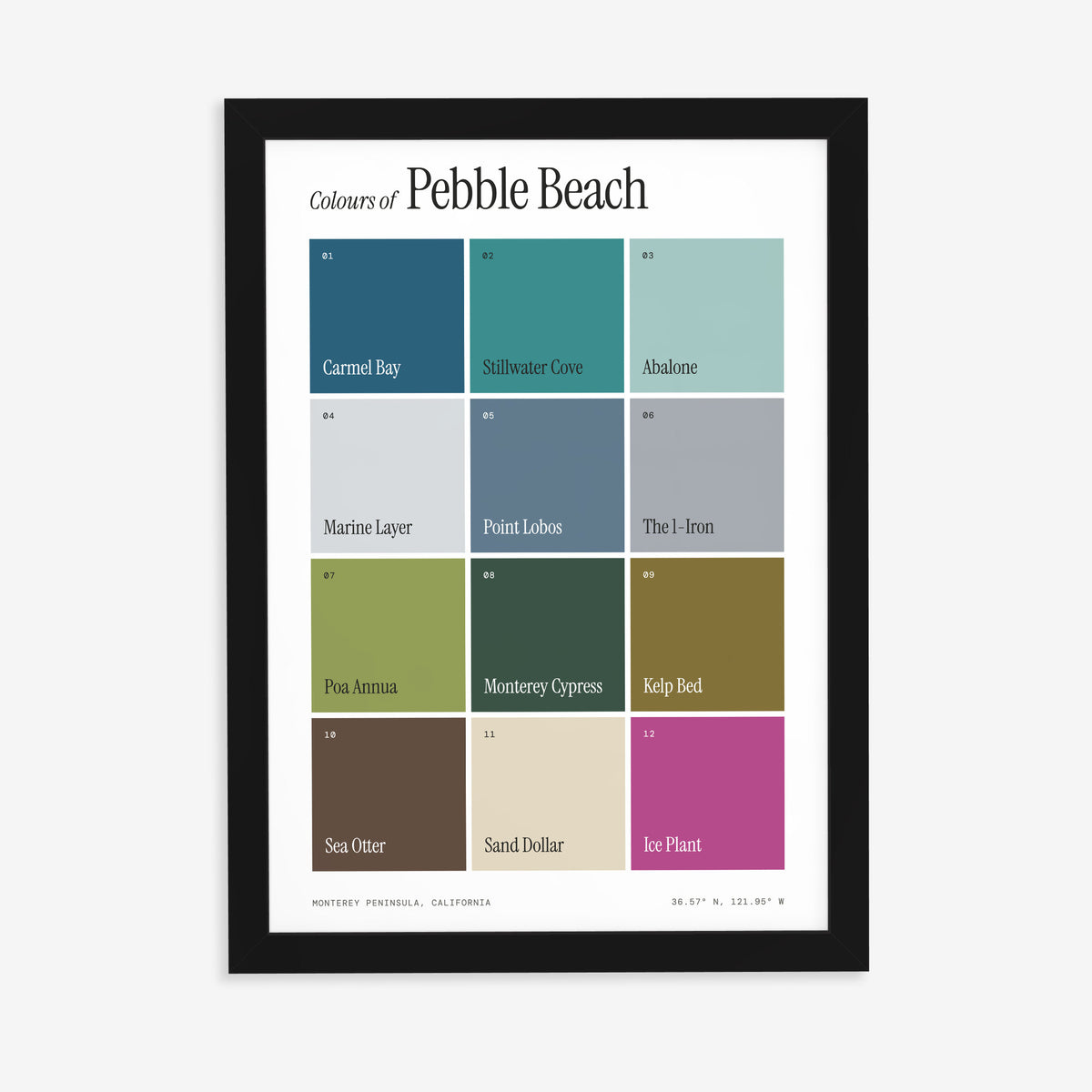 Colours of Pebble Beach print of twelve named colour squares on white, in a black frame on a plain wall