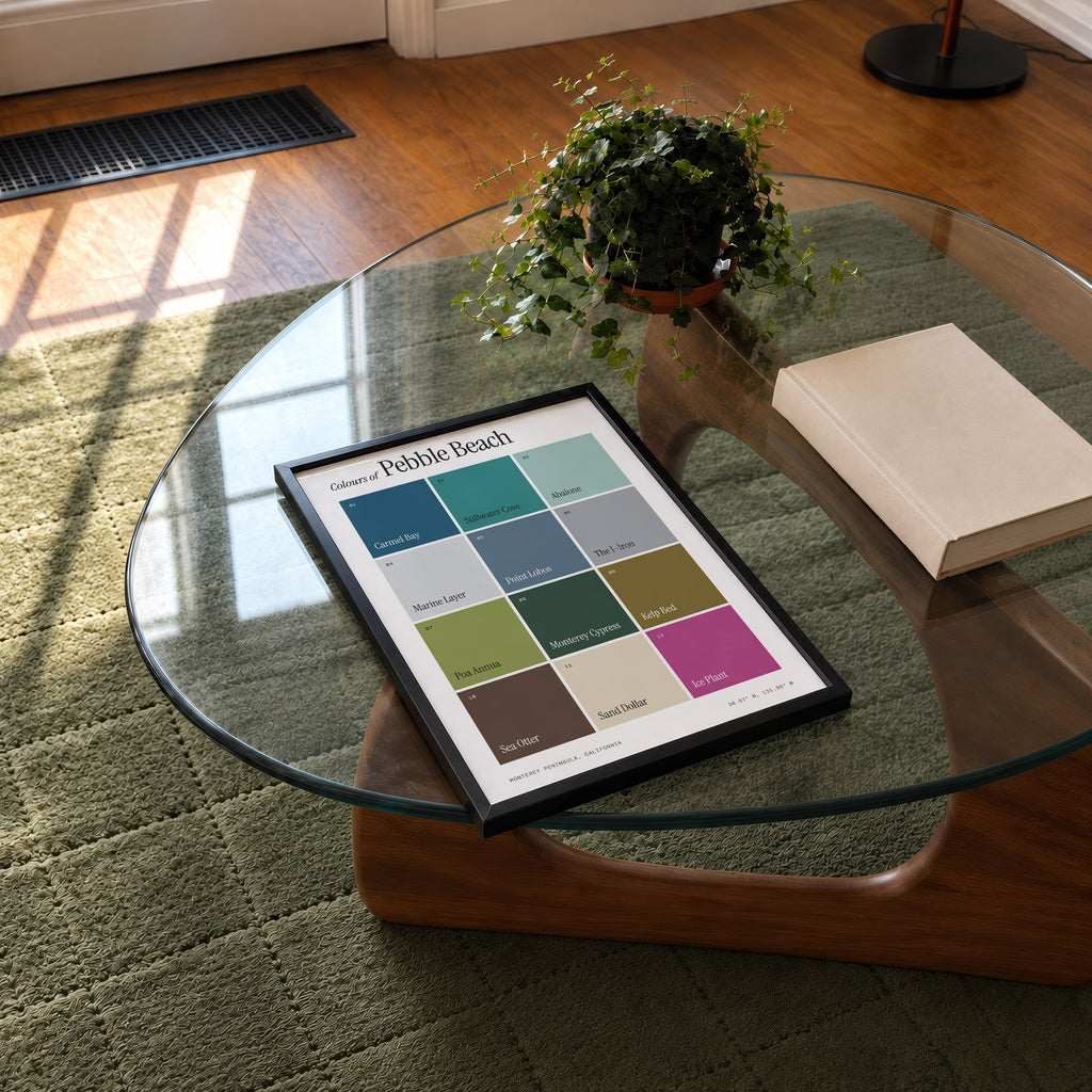 Colours of Pebble Beach print of twelve named colour squares on white, framed on a glass coffee table