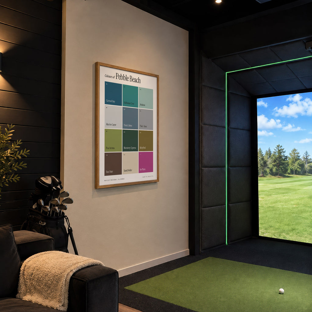 Colours of Pebble Beach print of twelve named colour squares on white, framed in a golf simulator room