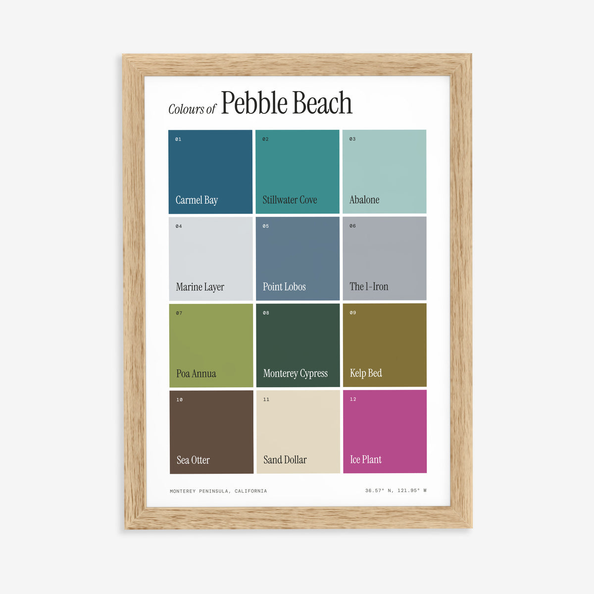 Colours of Pebble Beach print of twelve named colour squares on white, in a natural wood frame on a plain wall