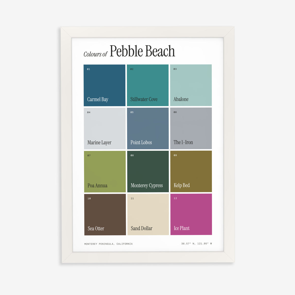 Colours of Pebble Beach print of twelve named colour squares on white, in a white frame on a plain wall
