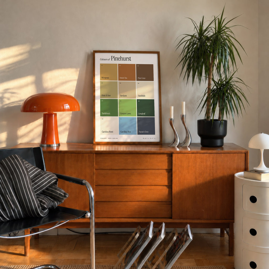 Colours of Pinehurst print of twelve named colour squares on white, framed on a mid-century sideboard beside an orange lamp
