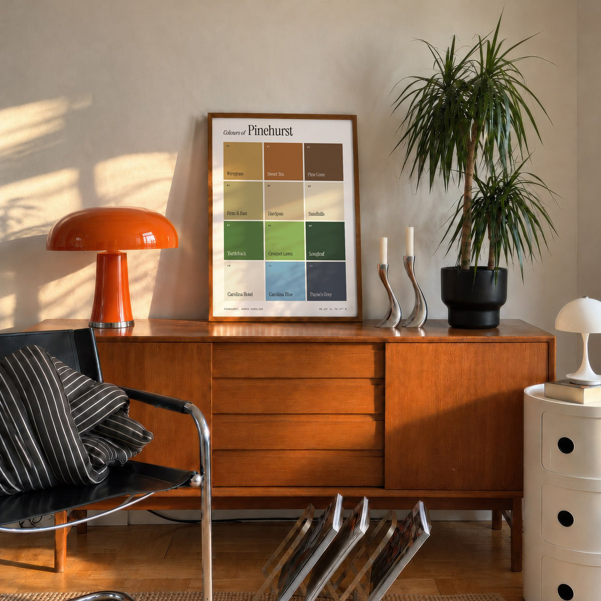 Colours of Pinehurst print of twelve named colour squares on white, framed on a mid-century sideboard beside an orange lamp