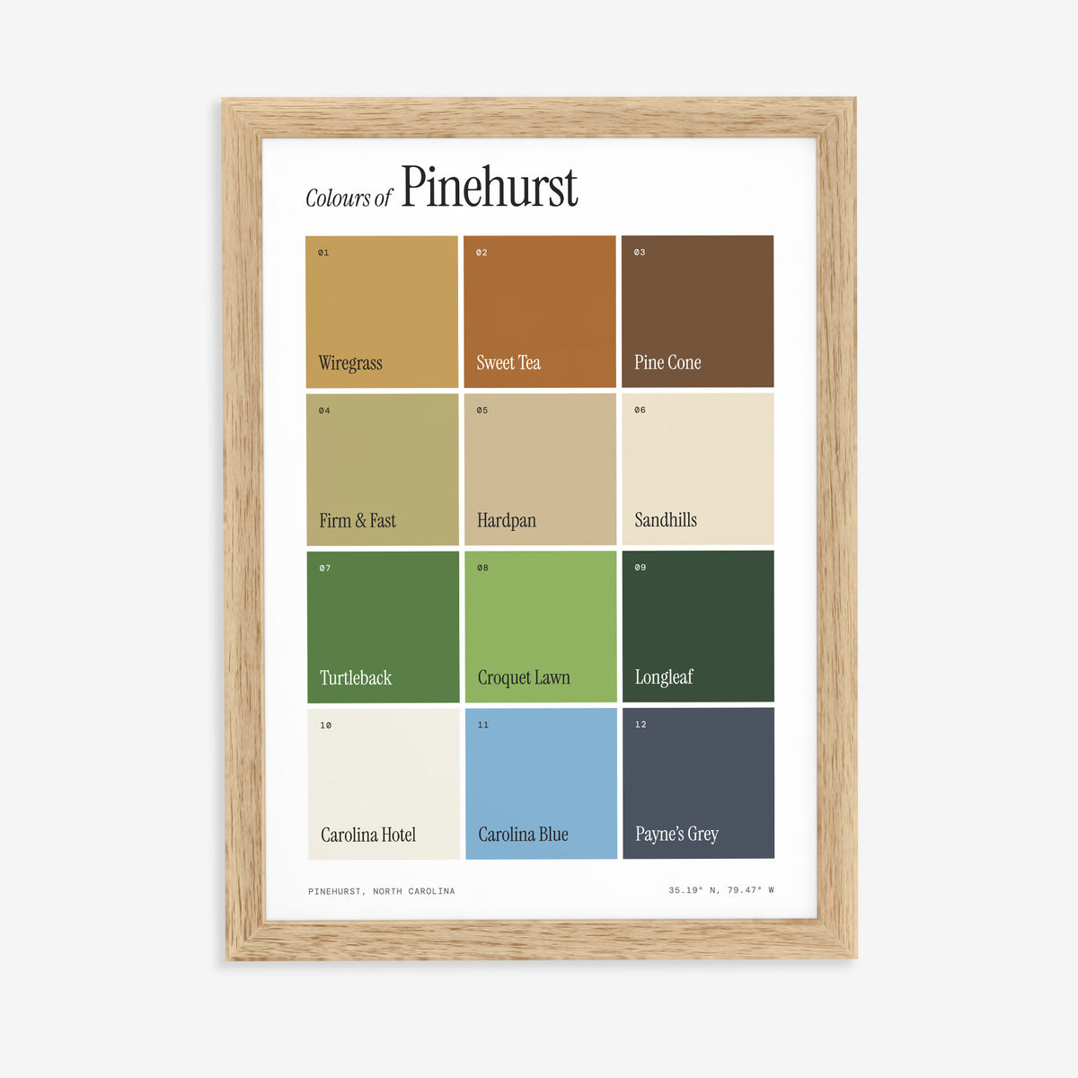 Colours of Pinehurst print of twelve named colour squares on white, in a natural wood frame on a plain wall