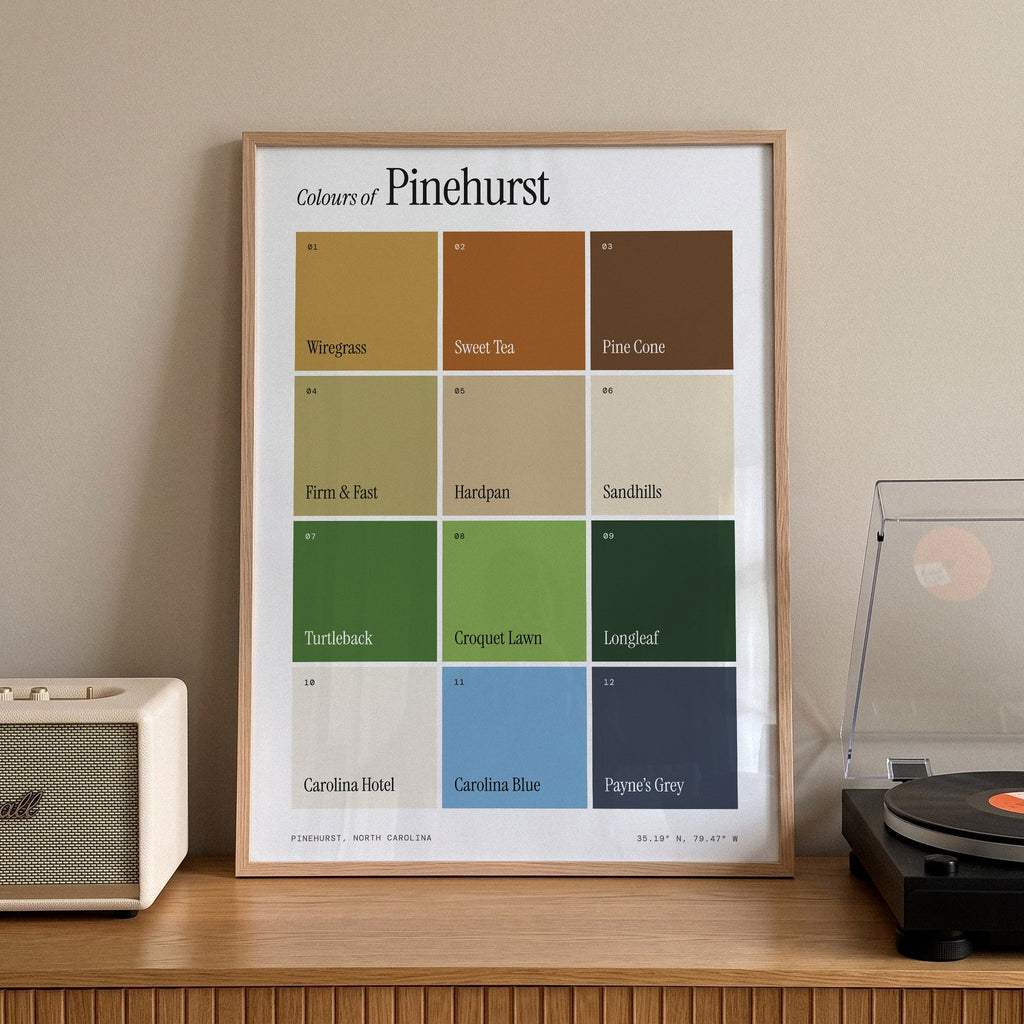 Colours of Pinehurst print of twelve named colour squares on white, framed on a sideboard beside a record player