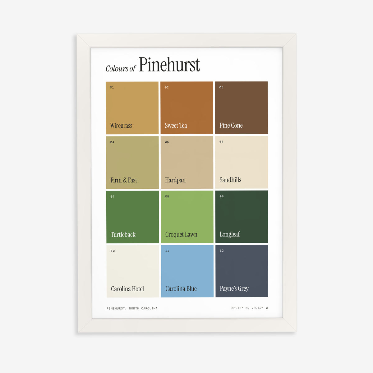Colours of Pinehurst print of twelve named colour squares on white, in a white frame on a plain wall