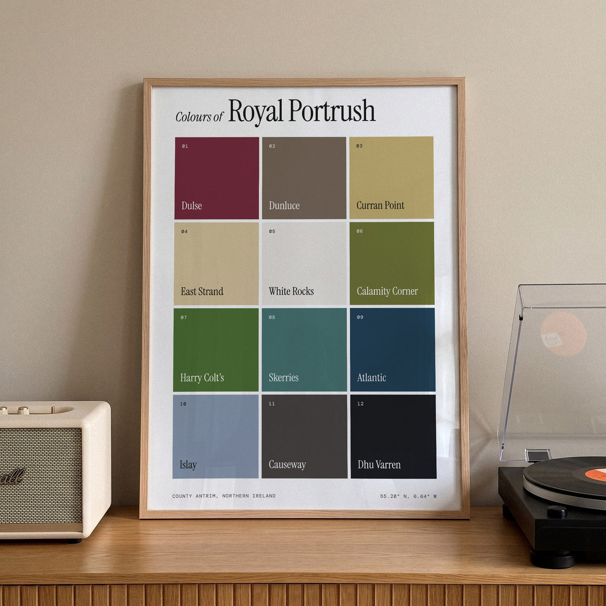 Colours of Royal Portrush print of twelve named colour squares on white, framed on a sideboard beside a record player