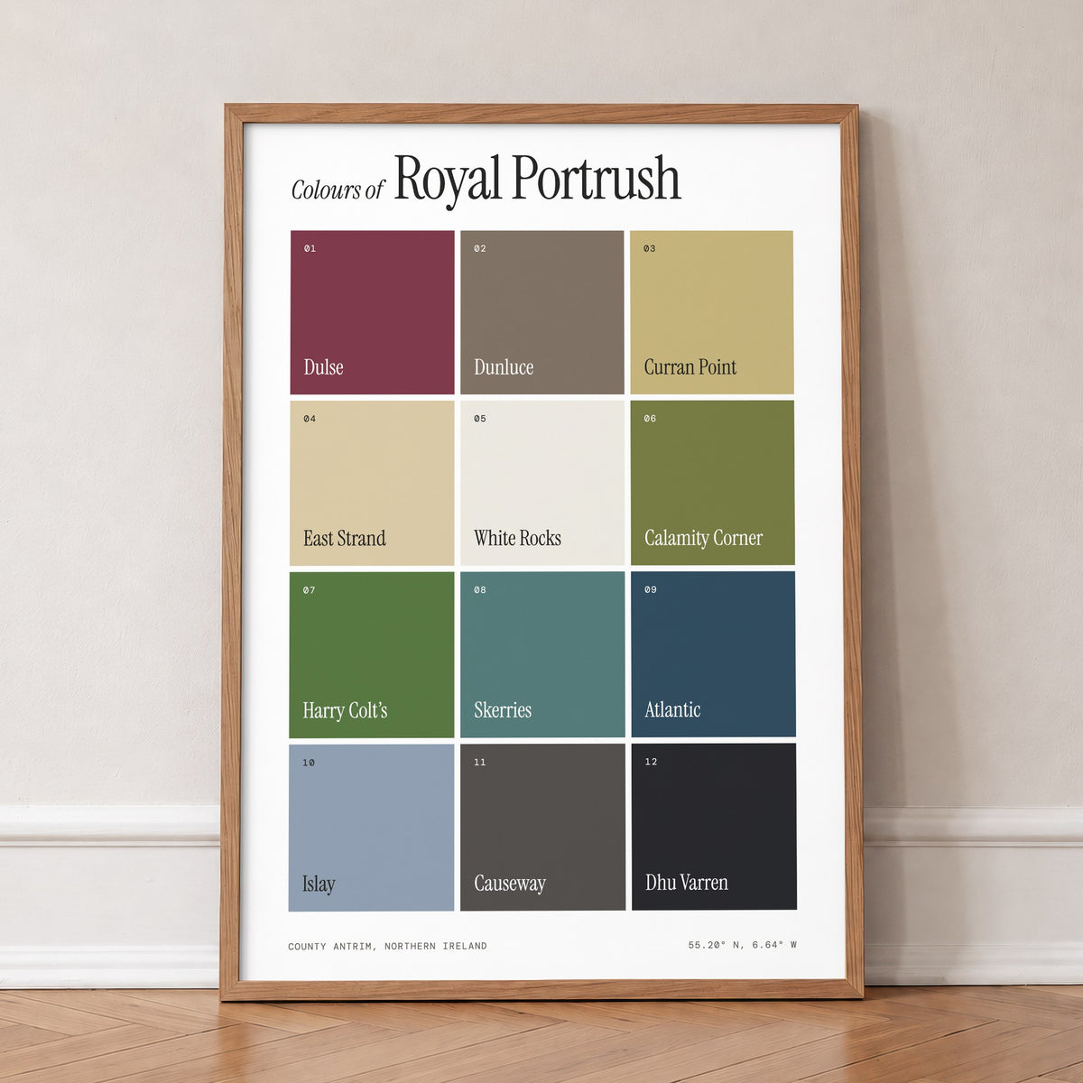 Colours of Royal Portrush print of twelve named colour squares on white, in an oak frame, leaning against a wall on a herringbone floor