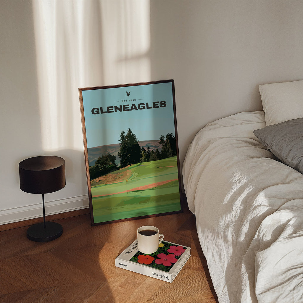 Gleneagles golf print of a green below pines and Perthshire hills, framed, leaning by a bed