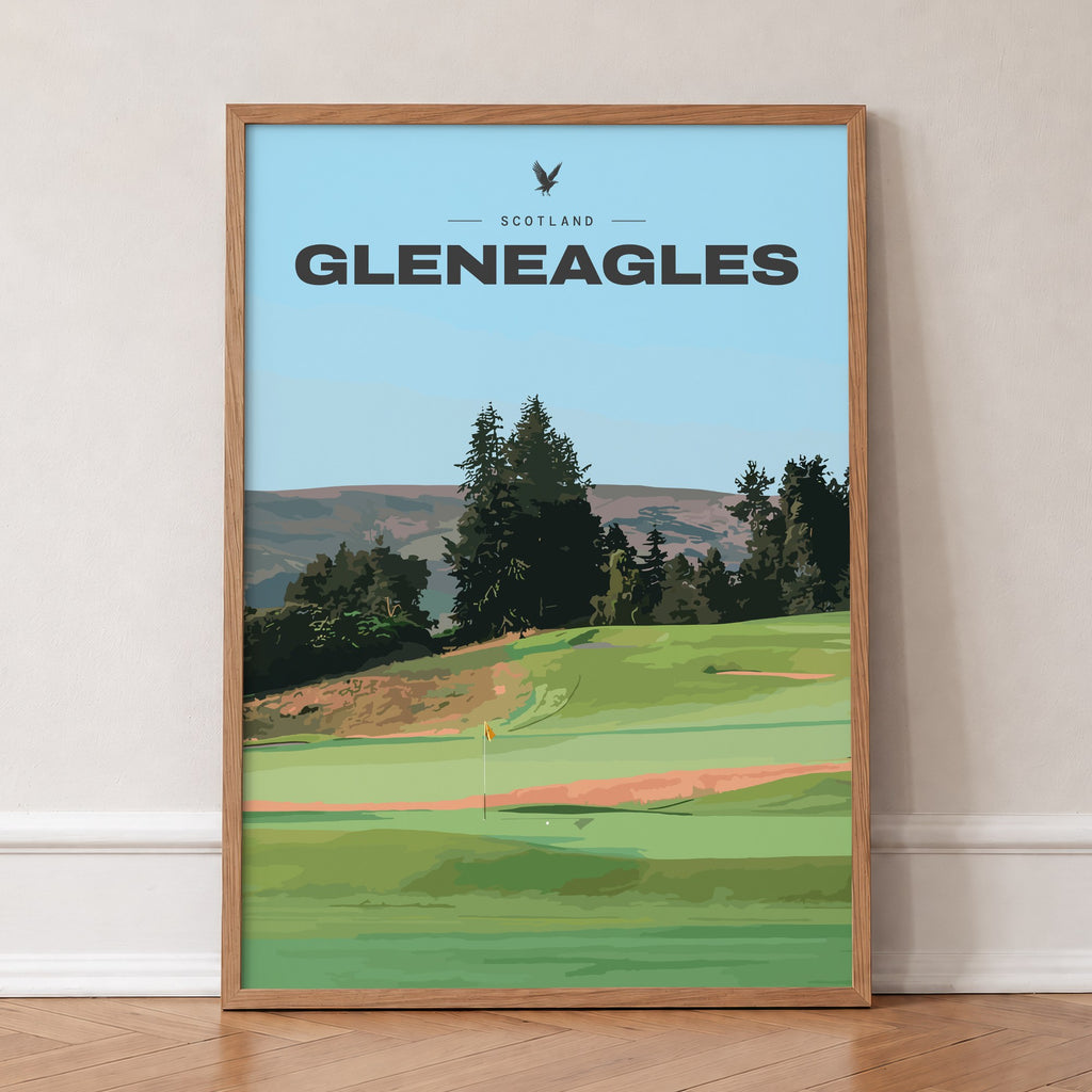 Gleneagles golf print of a green below pines and Perthshire hills, in an oak frame, leaning against a wall on a herringbone floor