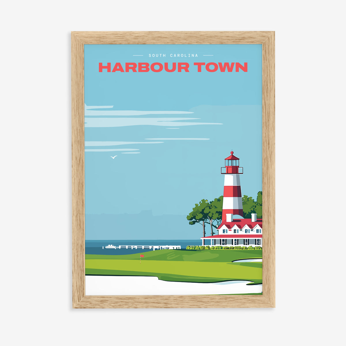 Harbour Town Lighthouse golf print of a striped lighthouse above a marina, in a natural wood frame on a plain wall