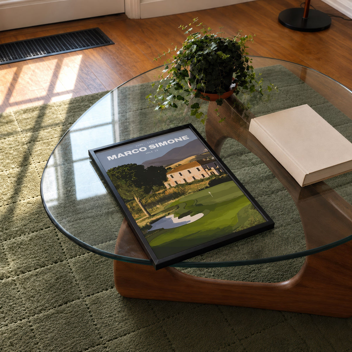 Marco Simone 13th hole golf print of a green below an old villa and hills, framed on a glass coffee table