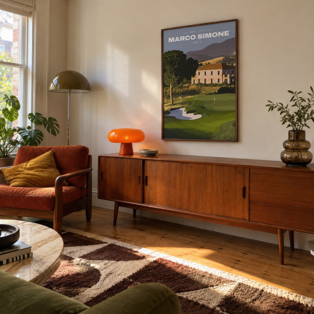 Marco Simone 13th hole golf print of a green below an old villa and hills, framed above a teak sideboard