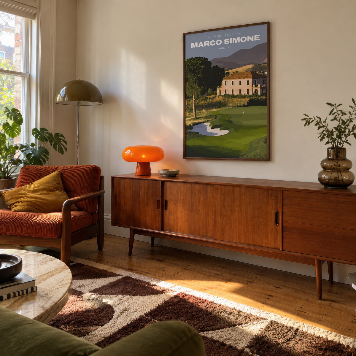 Marco Simone 13th hole golf print of a green below an old villa and hills, framed above a teak sideboard